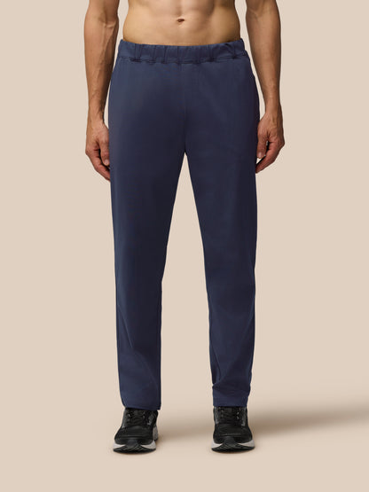 Front view of navy Elevated Lifestyle Tailored Trousers with elastic waist and Castore wordmark on left leg.