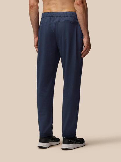 Back view of navy Elevated Lifestyle Tailored Trousers featuring back yoke zipped pocket and Castore badge near pocket.