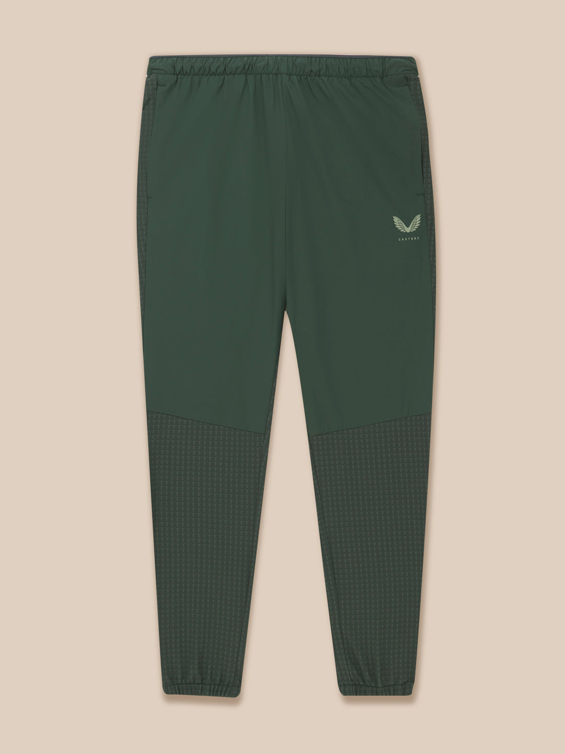 Front view of dark green Flex Winterised Woven Joggers laid flat with thigh Castore logo and panel details