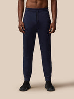 Full length navy Flex Thermo Pant on model with drawstring waist and ribbed cuffs.