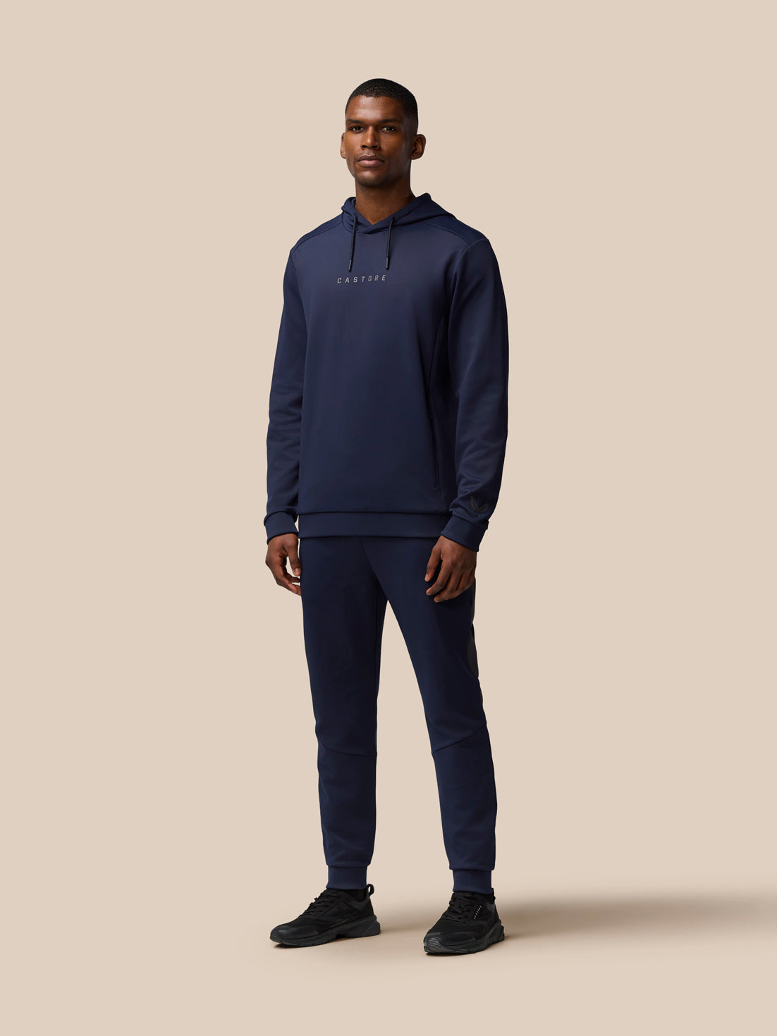 Male model wearing navy Flex Lifestyle Thermo Pant with drawstring waist and tapered legs.