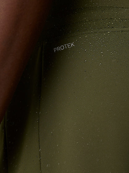 Close-up of olive green ProTek water resistant fabric with branding on the leg