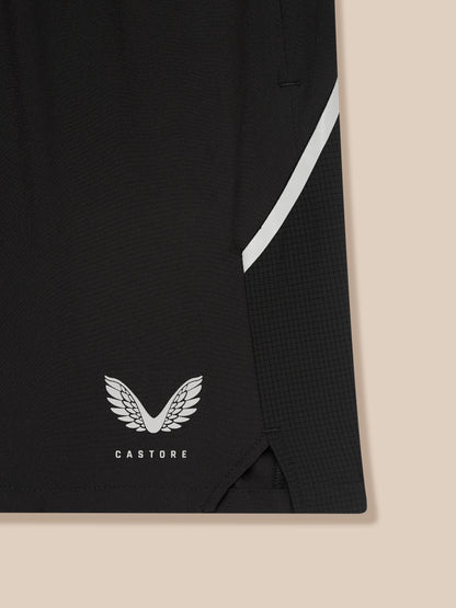 Close-up of Apex Training 6-Inch Shorts in black fabric with a white diagonal stripe and Castore logo at the hem