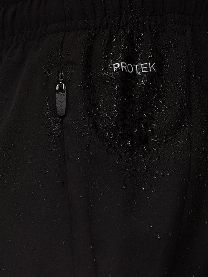 Close up of black Apex Training 6in shorts fabric with ProTek branding and a zipper pocket with water droplets