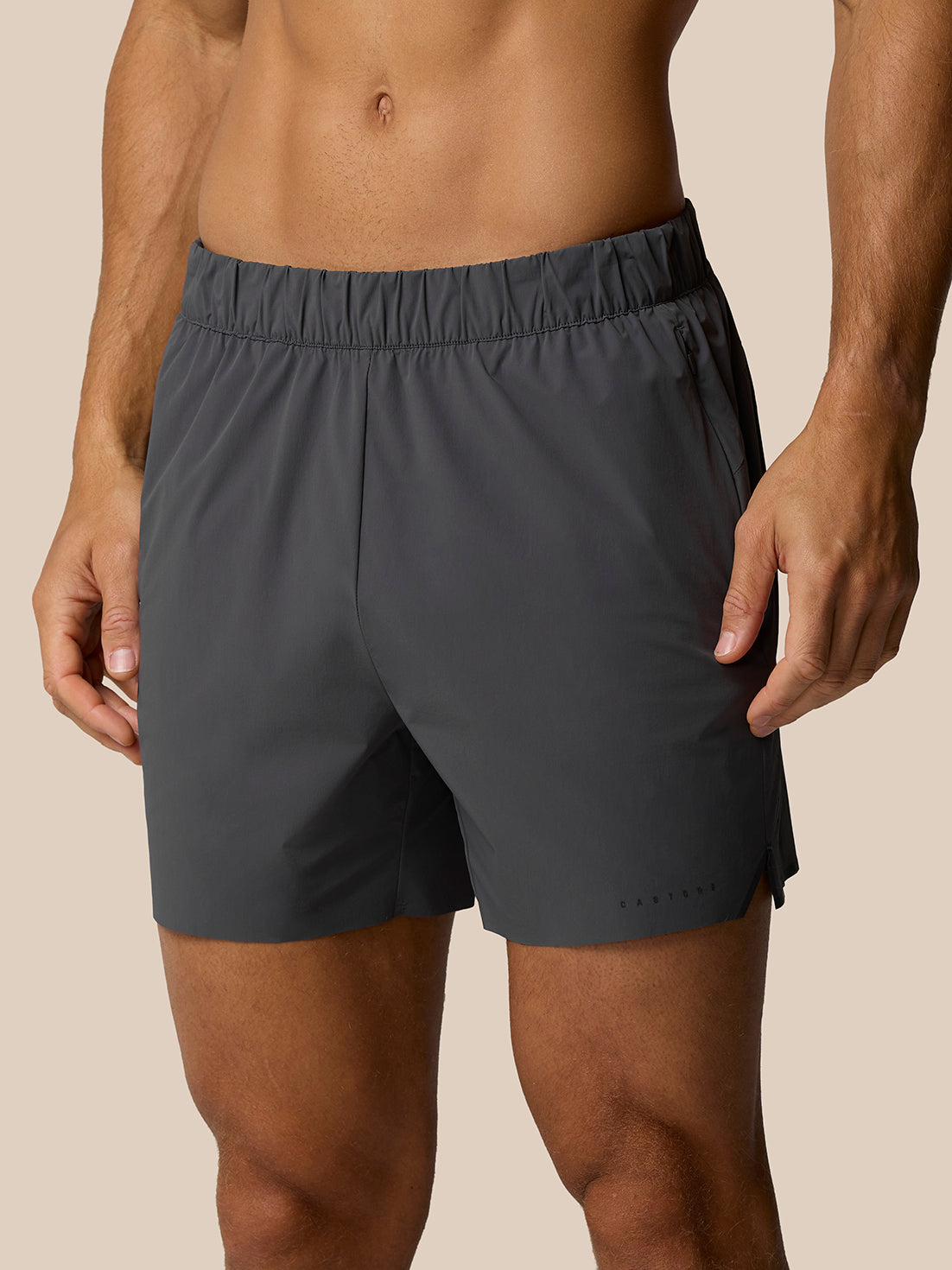 Front view of a man wearing Zone Training LVS 5 inch shorts in gunmetal with an elastic waistband