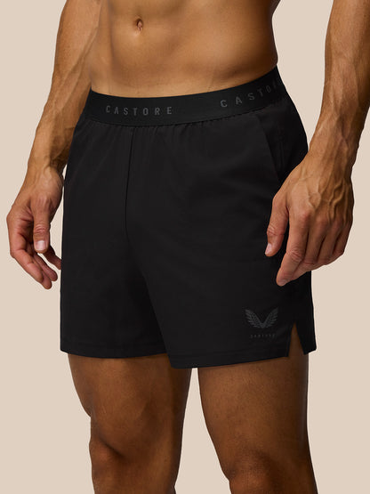 Close-up of black Adapt 5 Inch shorts waistband with Castore branding and a small wing logo on the leg