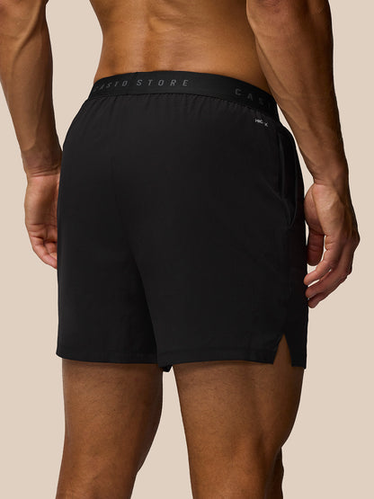 Back view of black Adapt 5 Inch shorts on a model with CASTORE waistband ProTek detail and a zip pocket