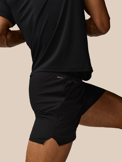 Side view of Adapt Training 5 Inch Shorts in black showing a waistband and zip pocket