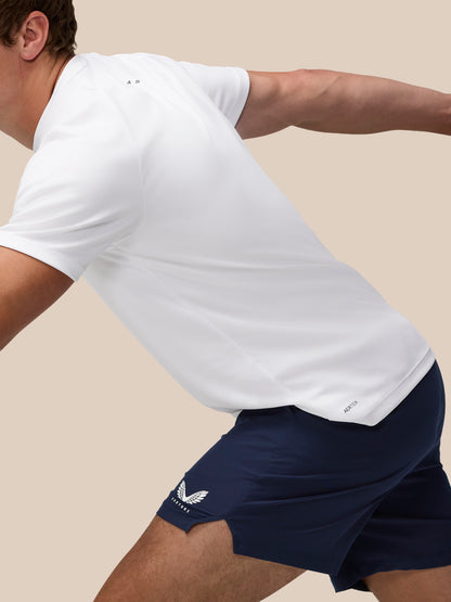 Model wearing white t shirt and navy Adapt 5 Inch Shorts in action