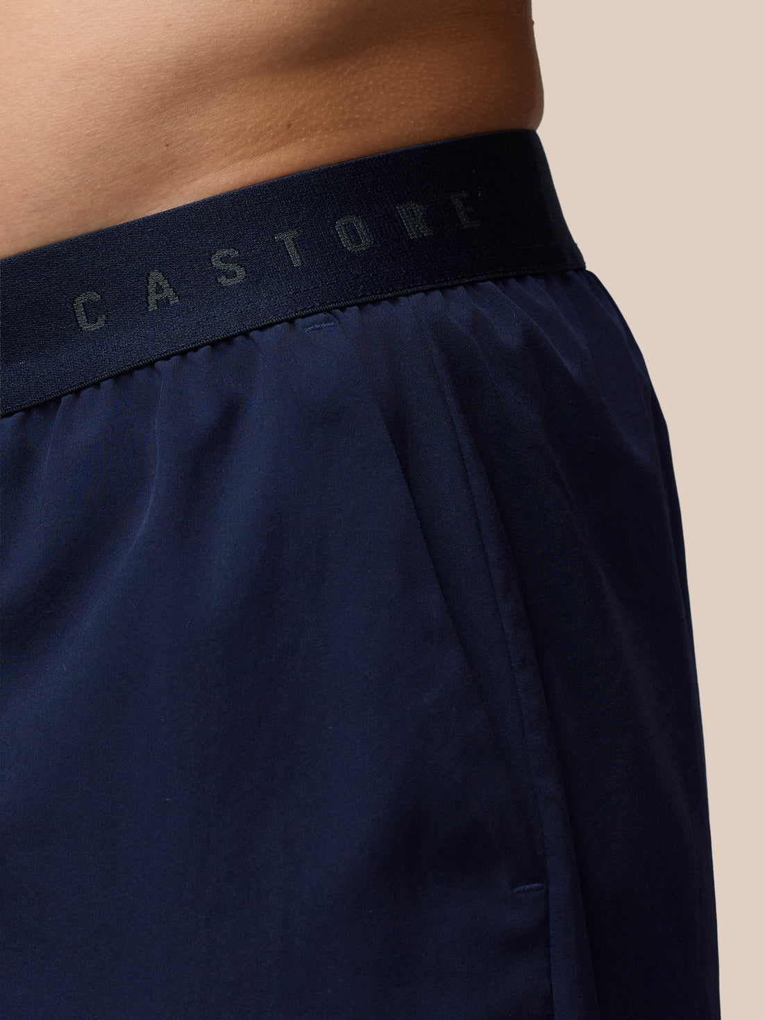 Close up of navy Adapt 5 Inch Shorts waistband with Castore branding