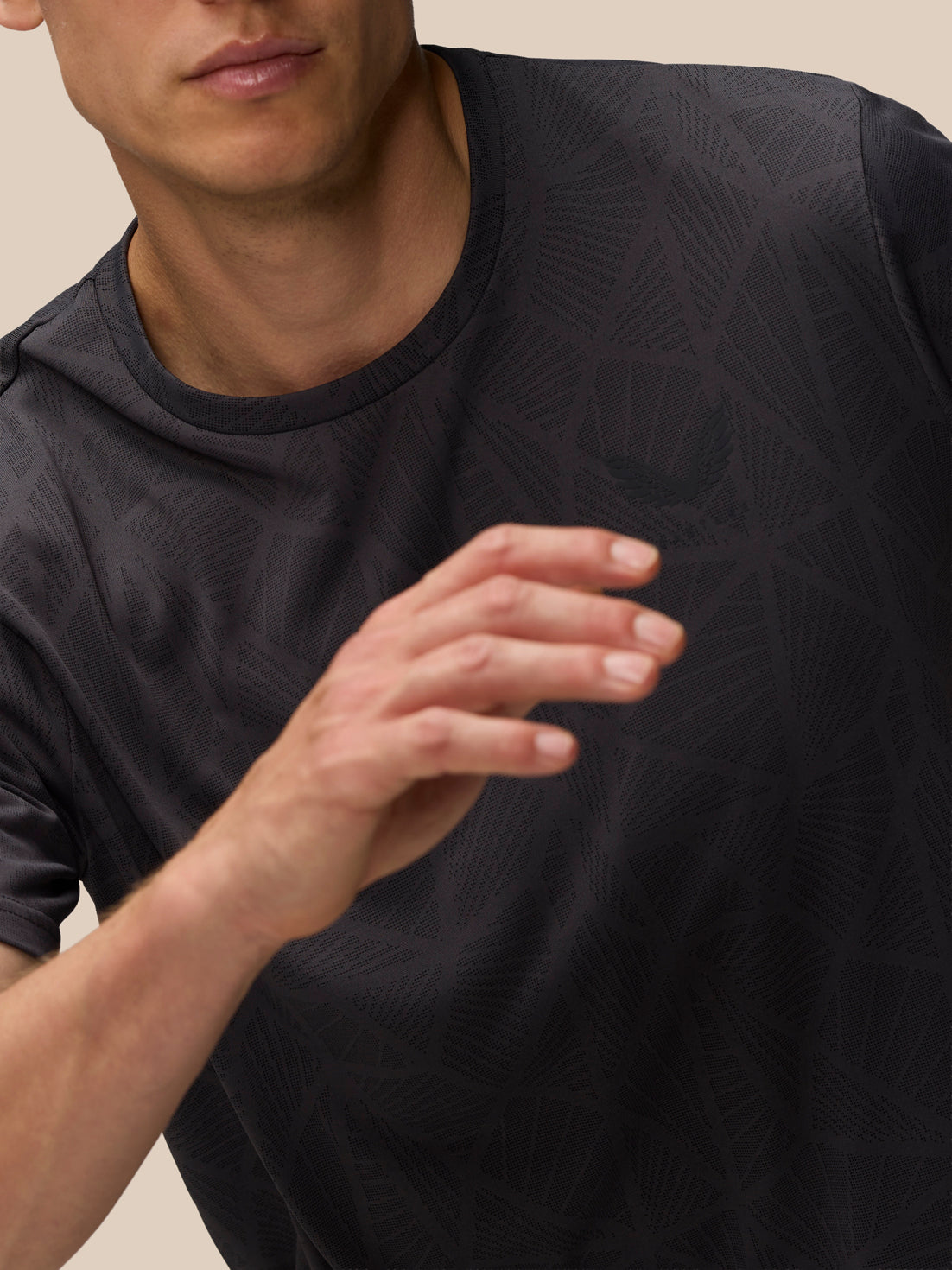 Close up of Flow Training Engineered Knit T Shirt fabric highlighting the geometric knit pattern and textured surface