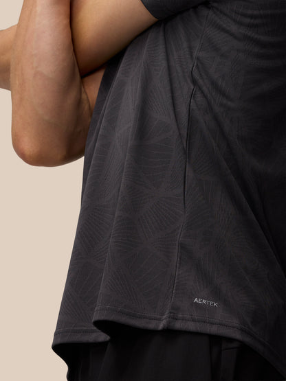 Close up of dark gray Flow Training Knit T-Shirt fabric showing geometric pattern and AerTek label