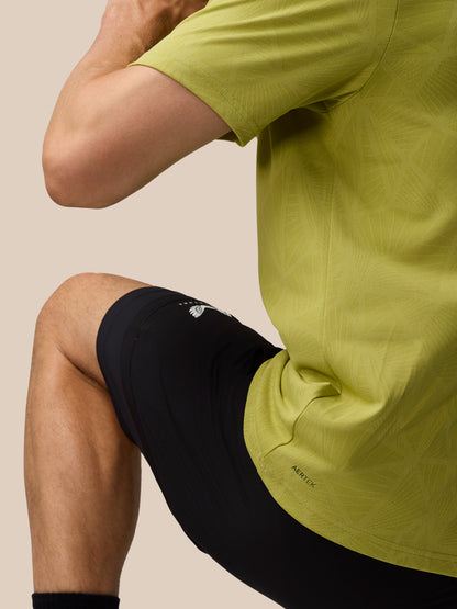 Rear and side view of a man in mustard Flow Engineered Knit T Shirt, highlighting the knit pattern and back neck tape.