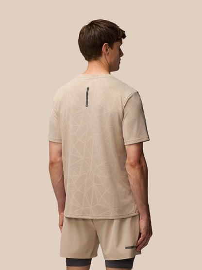 Back view of Flow Training Engineered Knit T Shirt with branded neck tape and beige geometric knit
