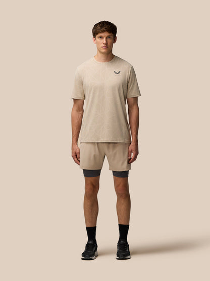Front view of Flow Training Engineered Knit T Shirt Mushroom Black with beige geometric knit and Castore logo on left chest