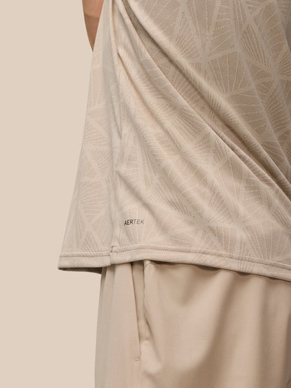 Beige mushroom Flow Engineered knit fabric with a geometric pattern and AerTek branding along the hem
