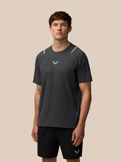 Rear view of gunmetal Apex Training T Shirt with Castore logo on back hem and branded shorts.
