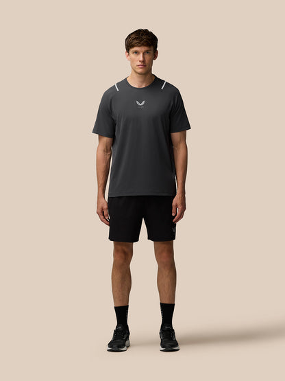 Male model wearing gunmetal Apex Training T-Shirt with reflective shoulder hits and Castore branding on chest