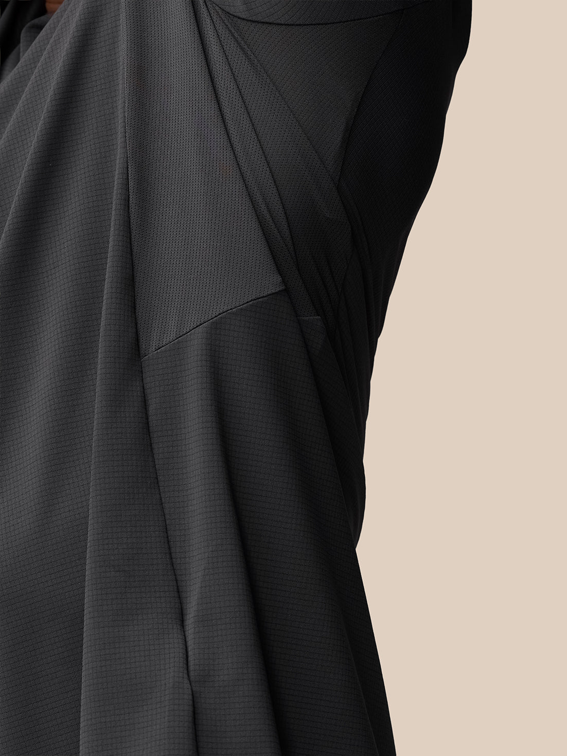 Close-up of dark Apex Training T-Shirt fabric showing mesh panels and Castore wordmark at back hem