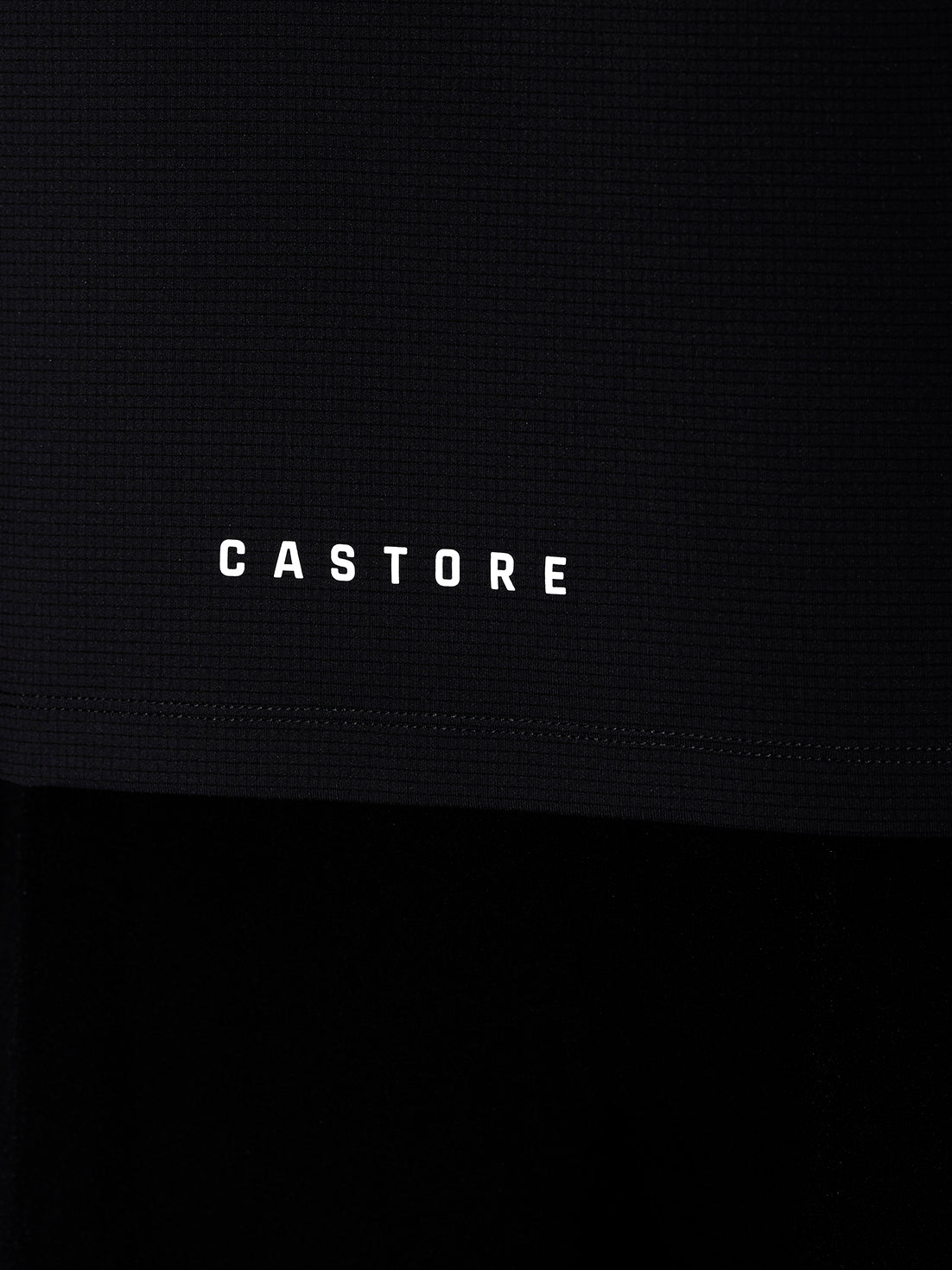 Castore wordmark on the hem of a dark Apex Training T Shirt fabric