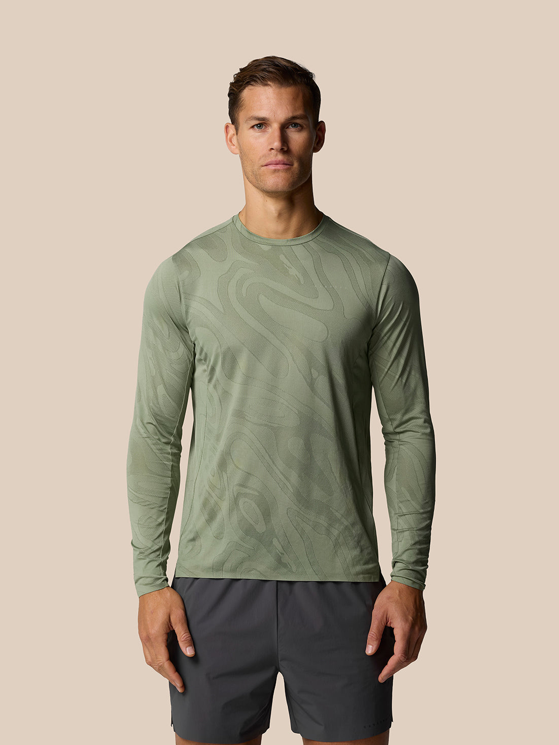 Male model wearing Thyme Zone Training LVS long sleeve top with abstract tonal pattern