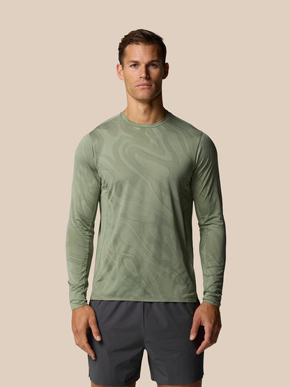Male model wearing Thyme Zone Training LVS long sleeve top with abstract tonal pattern