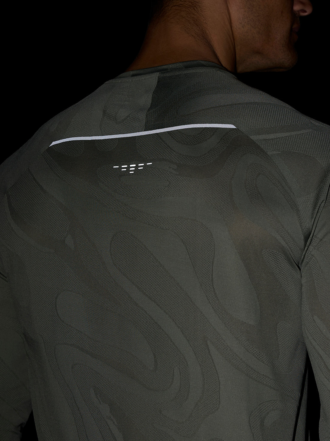 Back view of Zone Training LVS Long Sleeve Top in Thyme with camouflage pattern and white reflective back ventilation line.
