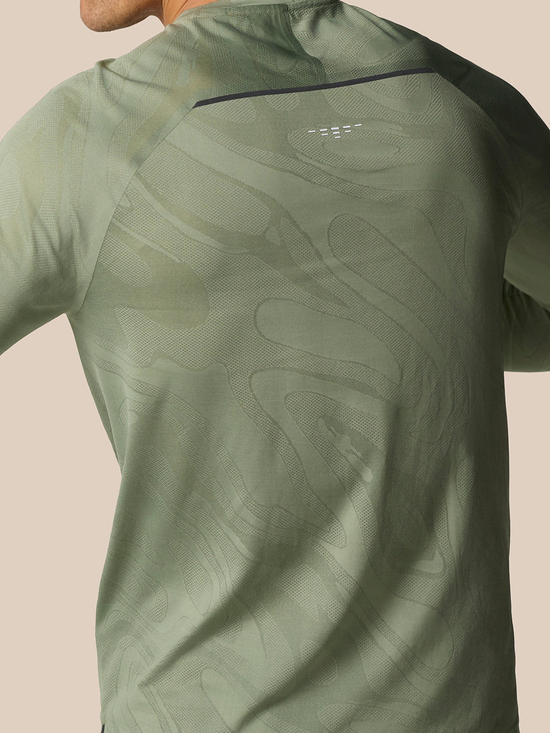 Close-up of the back of Zone Training LVS Long Sleeve Top Thyme highlighting the textured pattern and ventilation accents.
