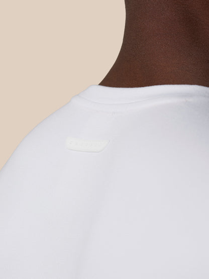 Back neck close-up of white Elevated Lifestyle T Shirt with Castore badge on the upper back