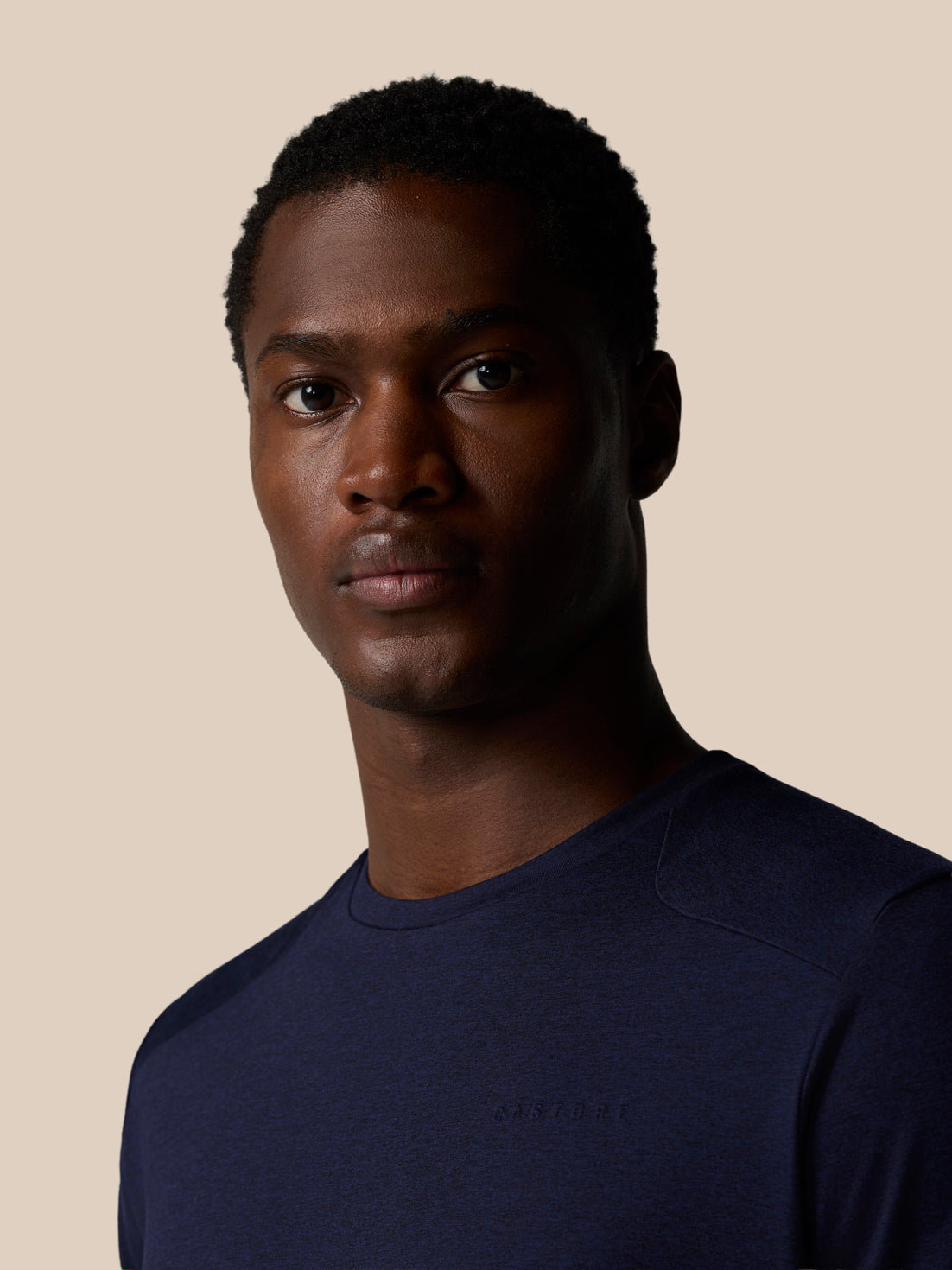 Male model wearing navy Elevated Lifestyle T Shirt with Castore logo on the chest.