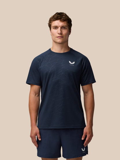 Front view of male model in navy Adapt Training T-Shirt with geometric pattern and Castore logo on chest