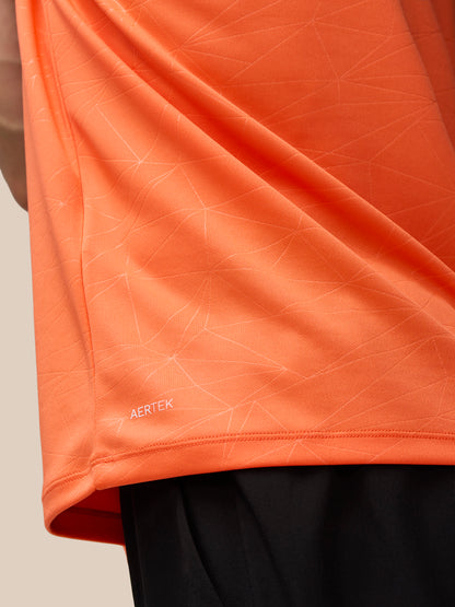 Back view of orange Adapt Training T-Shirt showing all-over geometric print and Castore wordmark along the back neck.