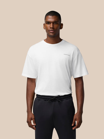 Male model in a white oversized T shirt with a small Castore logo on the chest front view