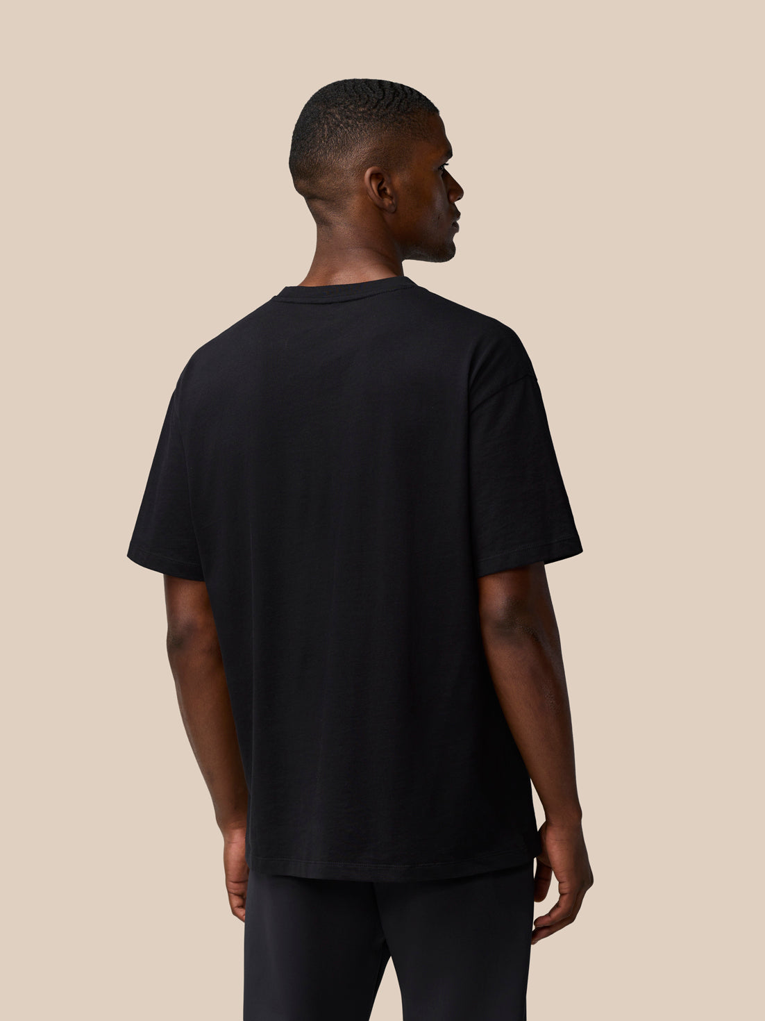 Back view of black Flex Cotton T-Shirt on a male model