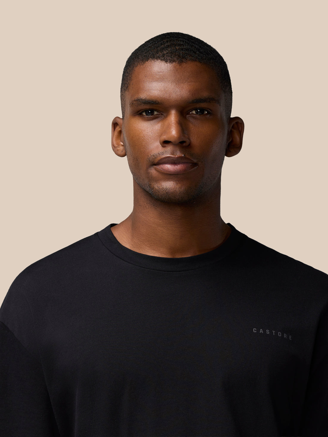 Front view of black Flex Cotton T-Shirt with small chest logo on dark fabric
