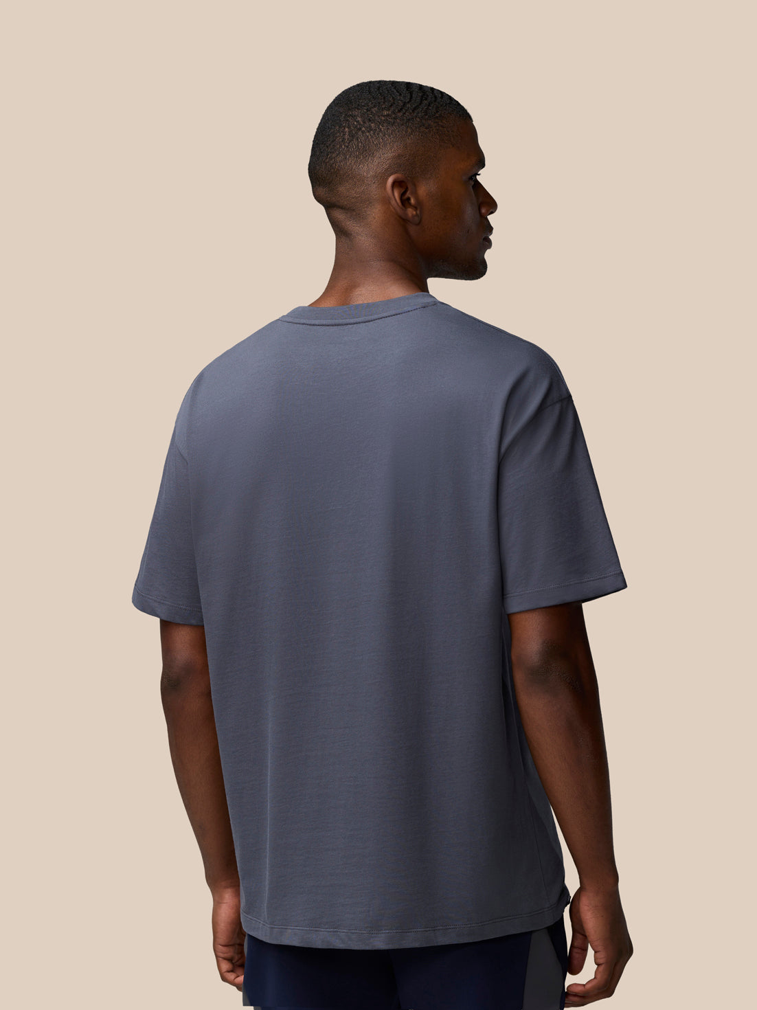 Back view of male model wearing pewter gray Flex Cotton T Shirt with short sleeves and relaxed fit.
