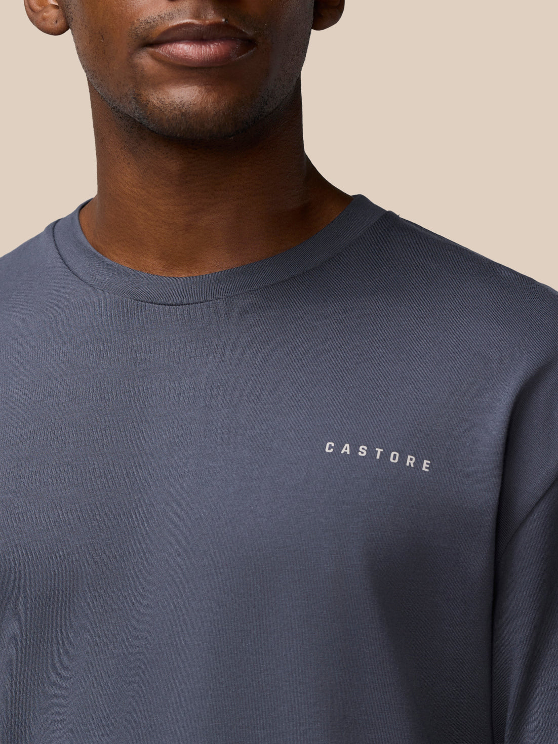 Close-up of pewter gray Flex Cotton T-shirt chest with Castore branding.