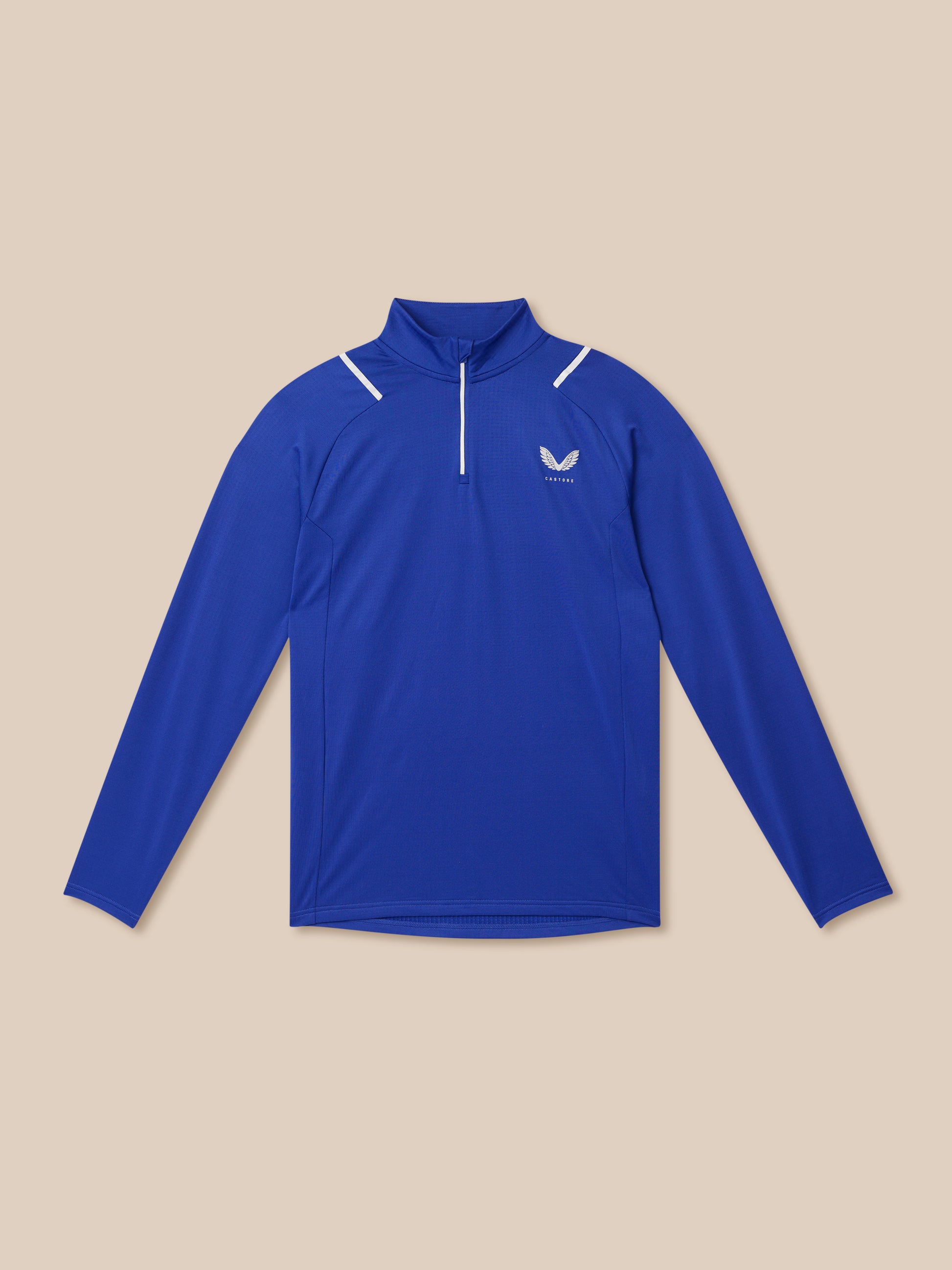 Blue Apex training winterised quarter-zip top with white zipper and chest logo on a beige background.
