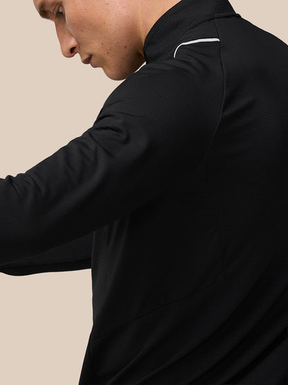 Back view of athlete in black Apex training top with subtle reflective shoulder detail