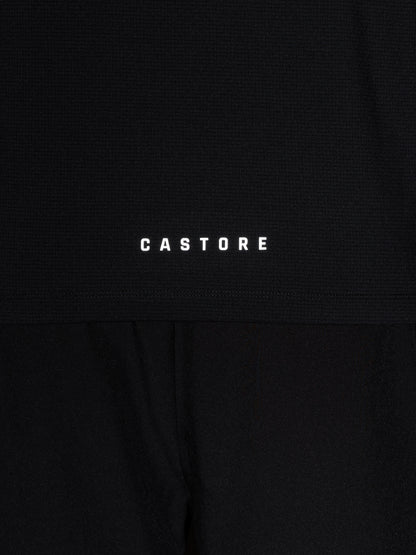 Close up of black knit Apex top with Castore wing logo and CASTORE wordmark on the chest