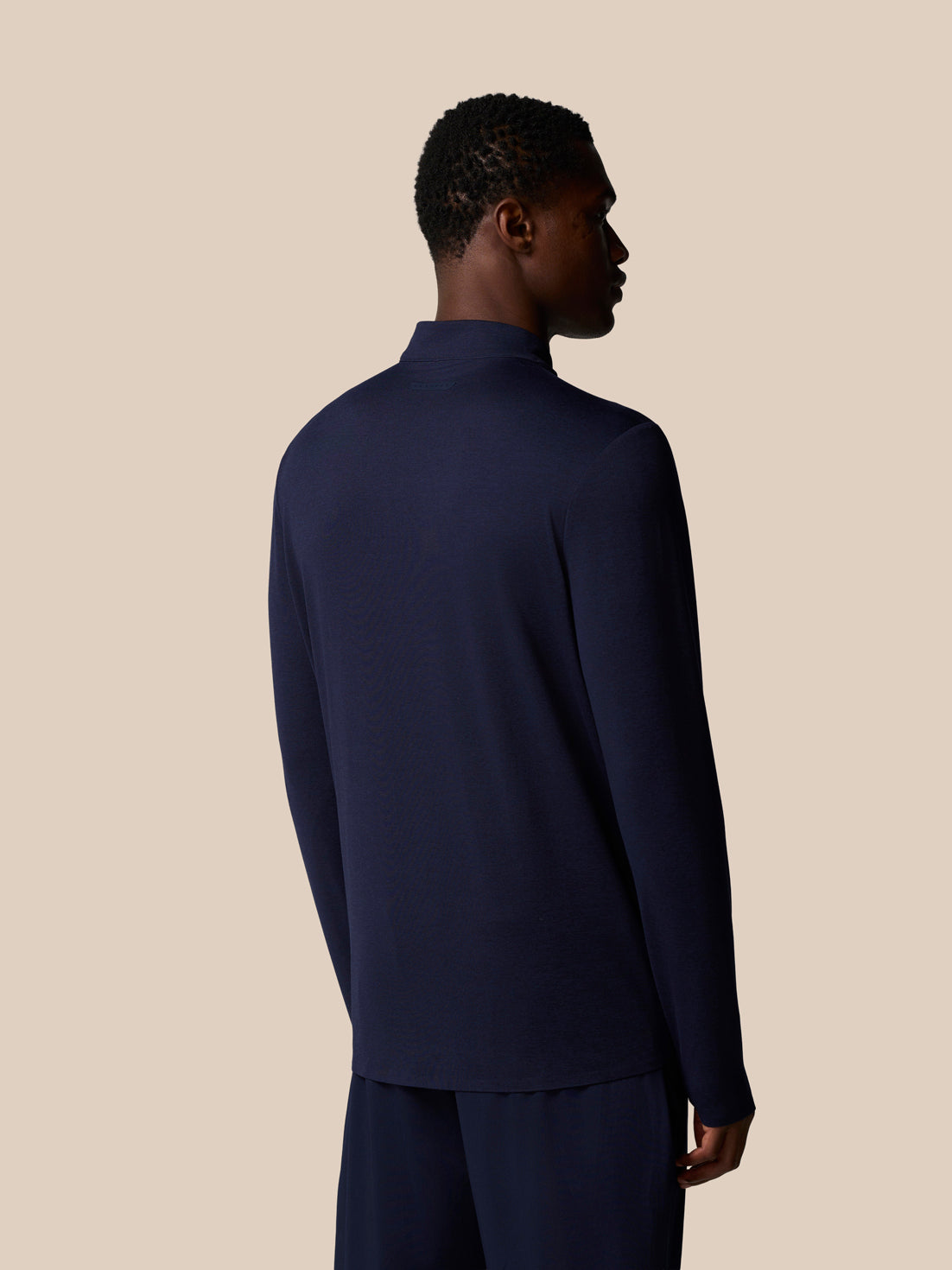 Back view of navy Elevated Lifestyle 1/4 Zip Top on a male model