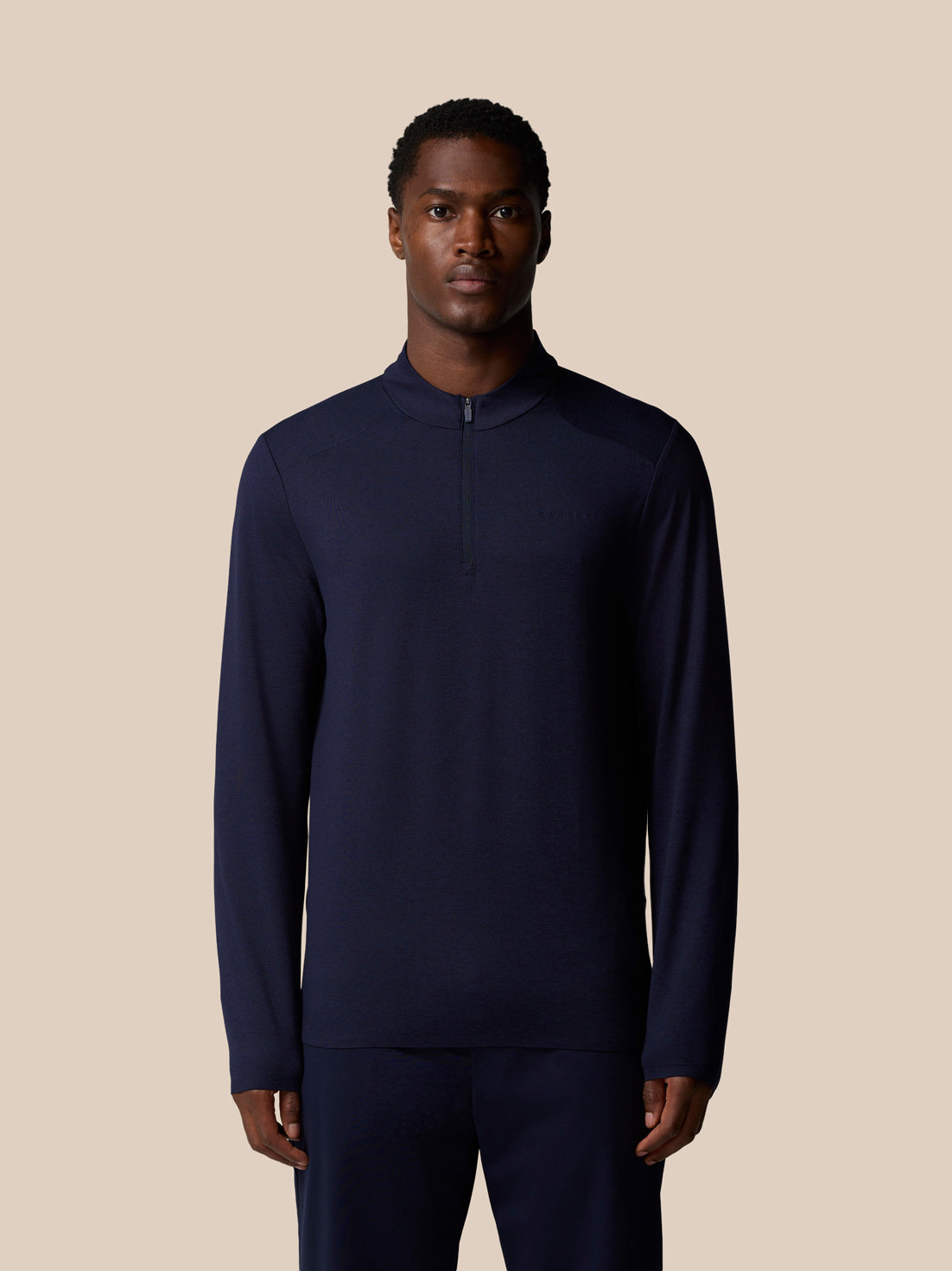 Front view of navy Elevated Lifestyle 1/4 Zip Top on a male model with center front zip