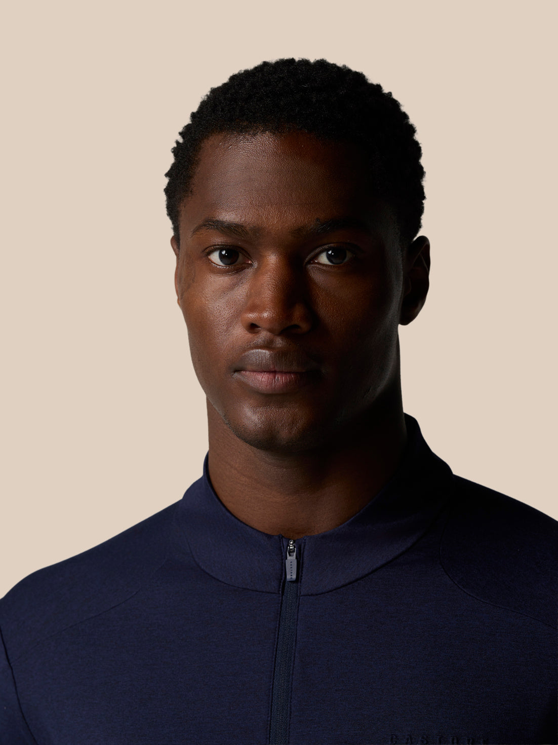 Close up of a male model wearing navy Elevated Lifestyle 1/4 Zip Top with zipped neck