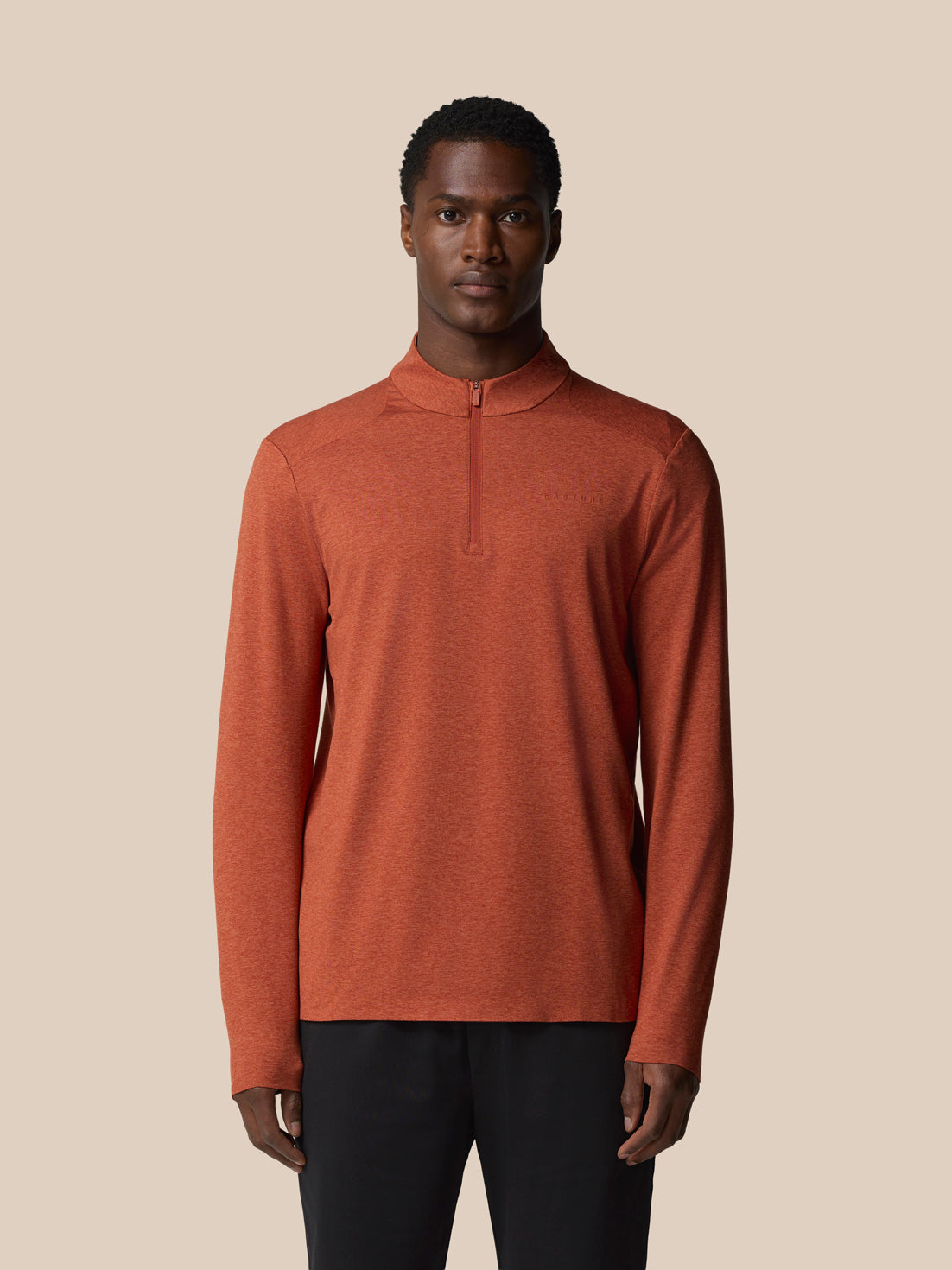 Male model wearing Elevated Lifestyle 1/4 Zip Top in dark rust with front zipper and long sleeves