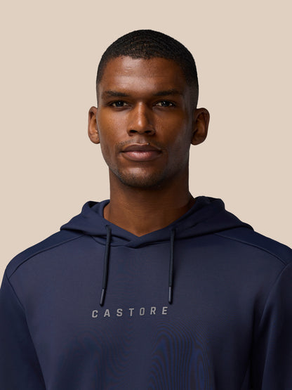 Model wearing navy Flex Lifestyle Thermo Hoodie with Castore branding on the center chest.