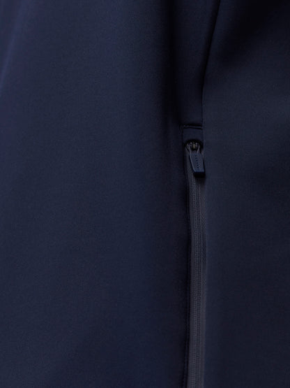 Close up of navy Castore Flex Thermo Hoodie fabric showing a zip pocket detail.