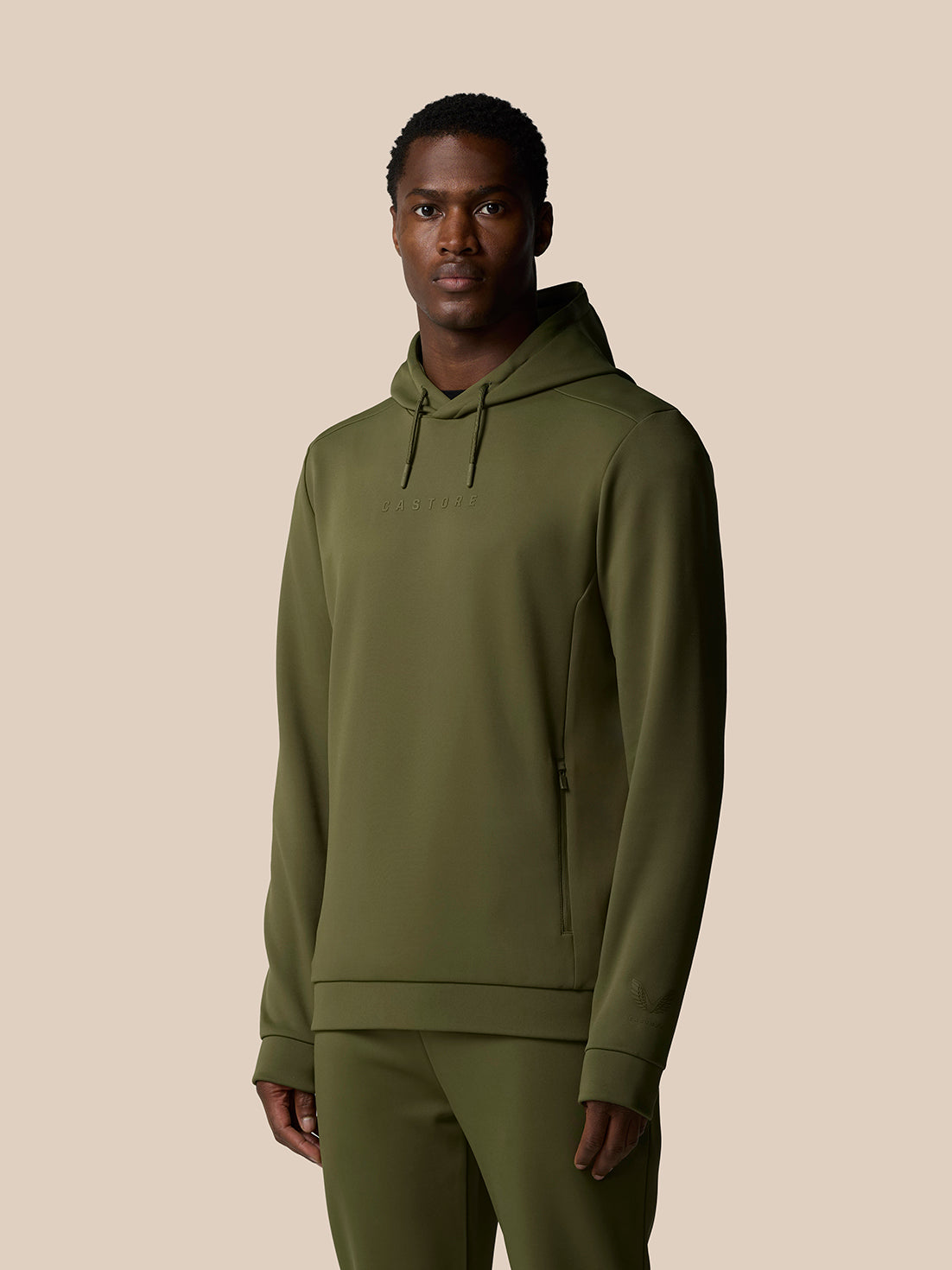 Male model in olive green Flex Lifestyle Thermo Hoodie with hood drawcords and chest logo