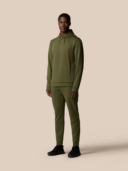 Full-body front view of a male model wearing an olive green Flex Lifestyle Thermo Hoodie and matching joggers
