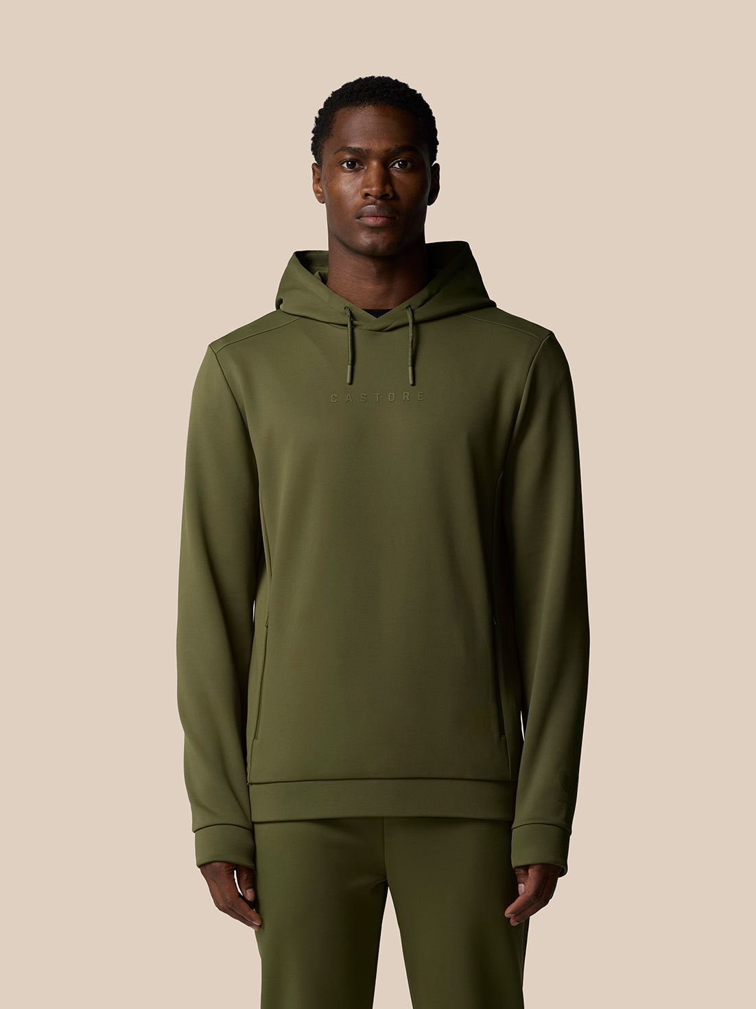 Male model wearing green Flex Lifestyle Thermo Hoodie with hood and front zipper chest logo