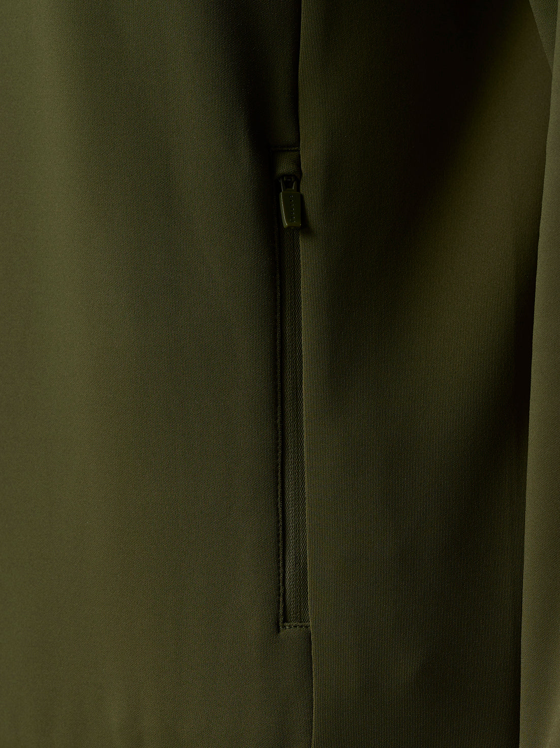 Close-up of olive green hoodie side zipper on the Flex Thermo design with textured knit fabric